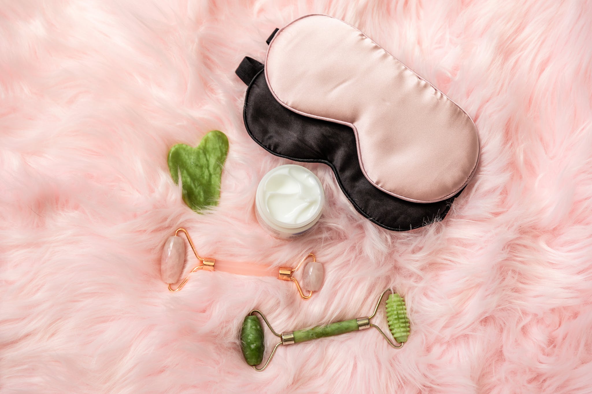 Beauty Care Products over a Pink Furry Fabric - sleep mask