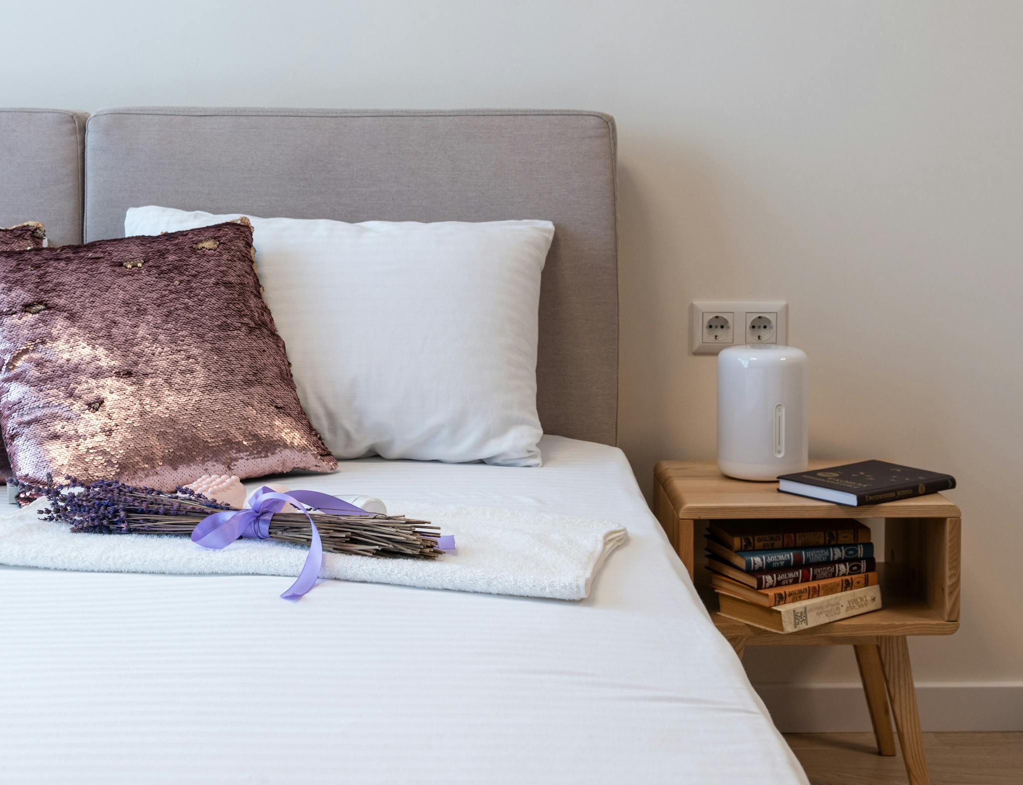 Lavender bouquet placed on bed in cozy bedroom in sunny morning - humidifier